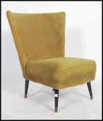 A retro 1950's lime green accent / easy chair having a wide tapered backrest and raised on short