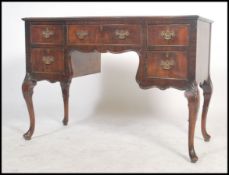 A good 1930's Queen Anne revival walnut writing table desk with arched central kneehole recess