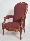 A 19th century large French fauteuil armchair in mahogany with spoon shaped back rest, shaped