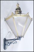 A large 19th century Victorian street lamp of hexagonal form having tapering glass panels with