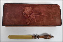 A brass and turned wood letter opener along with a pink cotton velvet letter box. Box measures 6
