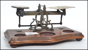 A set of vintage 20th century post office scales raised on a wooden base with bun feet having a