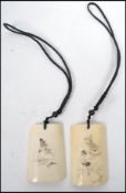 A pair of early 20th century Oriental Chinese ivorine pendant depicting scenes of an erotic nature