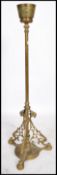 A 19th century Victorian heavy brass oil lamp stand raised on a pierced scrolled tripod base with