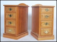 A pair of Edwardian satin walnut bedside chests of drawers / cabinets. Each raised on plinth bases