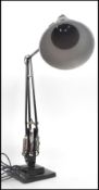 A 1940's Industrial pre-war Herbert Terry anglepoise lamp, raised on a cast metal two step base with