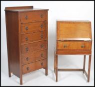 A 1930's oak upright pedestal chest of drawers being raised on squared legs together with a walnut