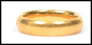 A hallmarked 22ct gold wedding band ring of plain form. Weighs 8.2 grams size N.