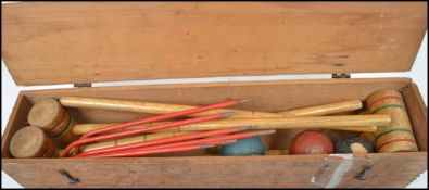 A vintage 20th century Triang croquet lawn set to include sticks, hoops, ball etc. complete in