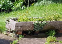 A large antique 19th century long  natural stone trough of rectangular shaped form being hewn hand