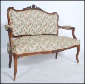 A good French early 20th century canape two seat sofa in mahogany having reeded, carved legs and