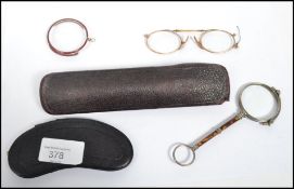 A group of three yellow metal testing as 14ct gold Victorian reading glasses, two in original