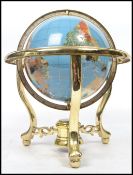 A 20th century desk top terrestrial globe inlaid with semi precious stones and raised on brass