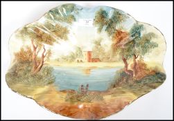 A vintage 20th century lustre ware dish of scalloped form having a hand painted scene. Measures 11