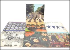 A collection of long play vinyl LP records by The Beatles to include Sgt Peppers, Abbey Road, Rubber