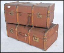 A pair of vintage 20th century canvas and wooden bound steamer trunks with locks and claps to
