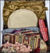 A collection of 19th century furnishing braids and fabrics including wool work and upholstery