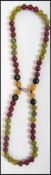 A contemporary bead necklace of honey, cherry and green amber beads. This can be worn long or