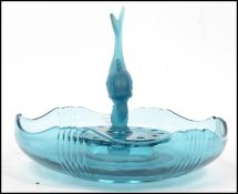 A mid century retro blue glass centre piece comprising bowl with frog centre and dolphin upright.