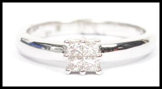 An 18ct white gold diamond ring having 4 stone square setting approx 25pnts total. Weight 4.1g /