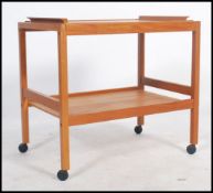 A 20th century retro BL Mobler Danish vintage teak wood drinks trolley having a lower tier shelf and
