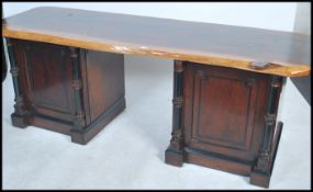 An up cycled twin pedestal desk having a pair of 19th century Regency pedestal bases surmounted with