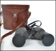A vintage 20th century pair of binoculars by Swift complete in original fitted case. Case measures