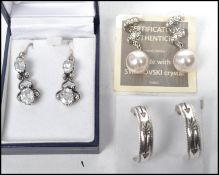 A group of three pairs of sterling silver earrings to include a silver drop earring set with four