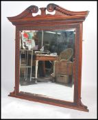 A late 19th / early 20th century large mahogany over mantel mirror  having a decorative frieze and