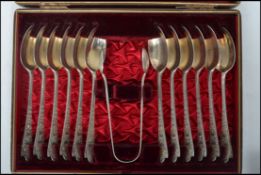 An early 20th century Edwardian set of 12 silver hallmarked tea spoons and sugar nips by Lawson & Co