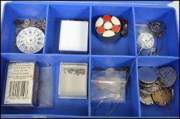 A collection of pocket watch parts to include movements, dials, cogs, Lanco gold movement, screws