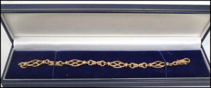 A 9ct gold ladies bracelet of bar link form having spiral twist spacers, set with a 9ct gold lobster