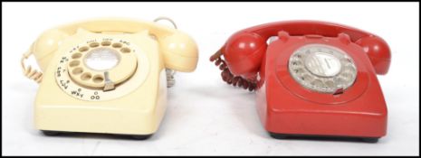 Two vintage mid century retro ring dial telephones in red and beige colourways with phones atop.
