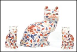 A group of Oriental Chinese ceramic cats decorated in an Imari leaf pattern with ochre red character