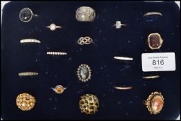 A collection of 18 costume dress jewellery rings to include white stone, gilt eternity etc. Please
