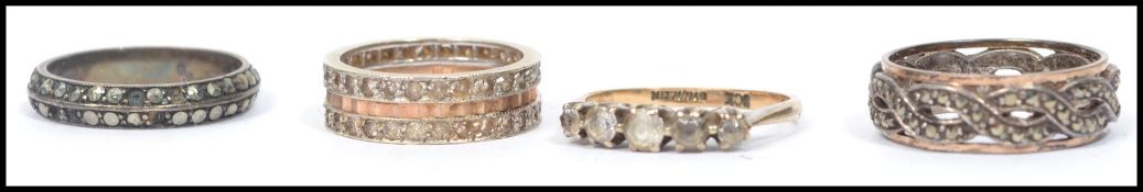 A group of three 9ct gold rings to include two marcasite eternity rings and a five stone ring. Total