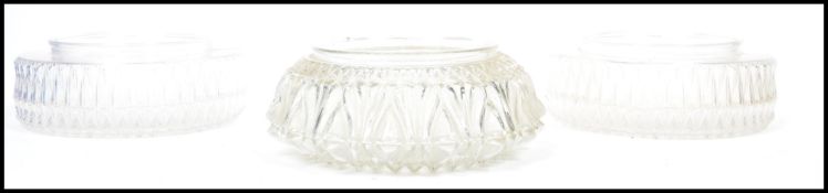A group of three vintage mid century glass ceiling light shades of pressed glass form. Two being a
