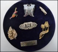 A collection of sterling silver dress brooches to include a enamel pheasant brooch, Niello butterfly