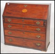 A 19th century Georgian mahogany inlaid bureau desk having a series of graduating drawers beneath