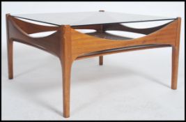 A rare 1970's large G-Plan teak and rattan weave coffee table of square form having shaped