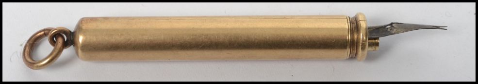 An early 20th century yellow metal tests as 9ct gold propelling pencil and pen compendium with