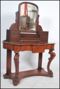 A Victorian mahogany duchess dressing table raised on turned supports with serpentine shaped