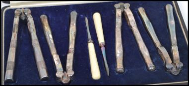 A cased set of vintage early 20th century silver plated lobster / crustacean crackers and picks