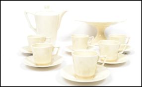 A vintage 20th century Crown Ducal six person tea service consisting of cups, saucers, teapot, tazza