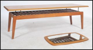 A retro / vintage mid 20th century retro teak wood floating frame coffee table raised on tapered