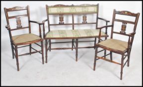 A pair of Edwardian marquetry inlaid salon armchairs together with a matching two seat salon sofa