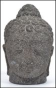 A vintage 20th century Balinese carved deity figure head of Dewi Sri Goddess, carved from lava.