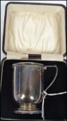 A hallmarked silver early 20th century Christening cup tankard of plain form having a shaped