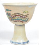 A 19th century Oriental Chinese ceramic sake cup depicting a dragon chasing a flaming pearl with