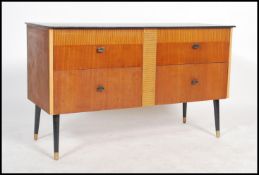 A vintage retro 20th century sideboard of small proportions having an ebonised top with four drawers